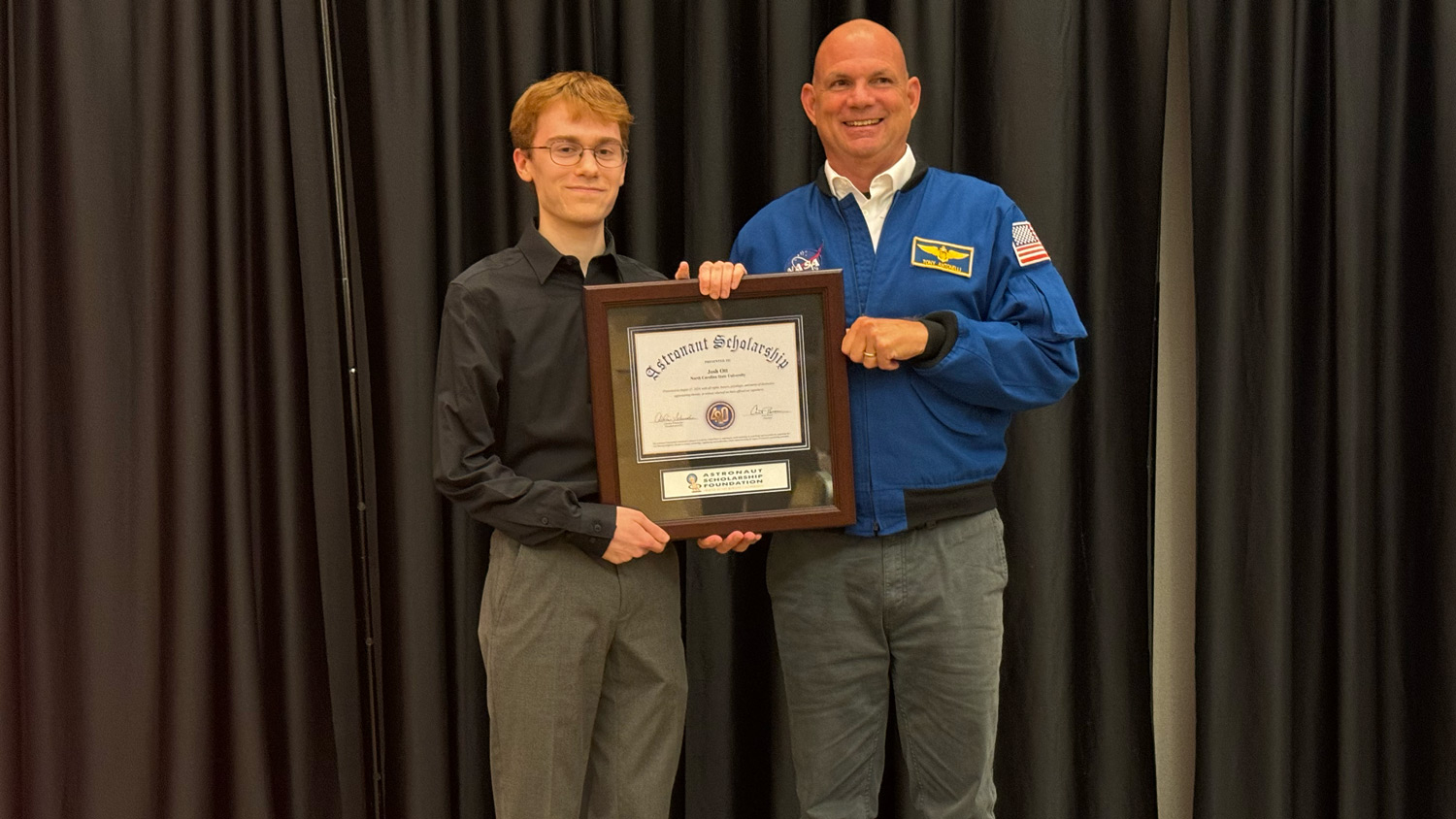 Veteran NASA Astronaut Tony Antonelli presents College of Sciences student Josh Ott with an Astronaut Scholarship award at NC State's Talley Student Union