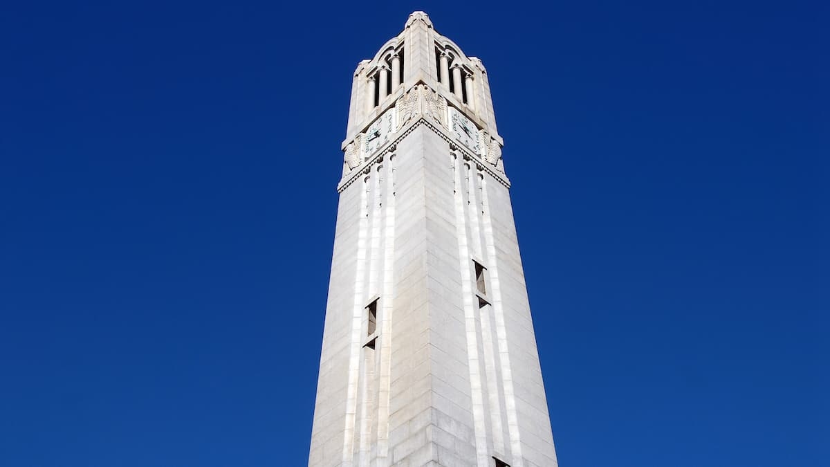 NC State Belltower under a crisp blue fall sky.